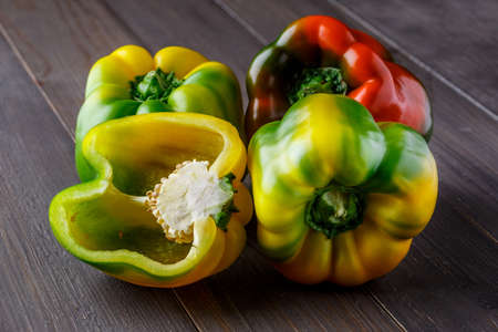 Fresh red, orange, green and yellow sweet bell paprika close up.fresh pepper on the table. background with bell peppers. Healthy lifestyle.の写真素材