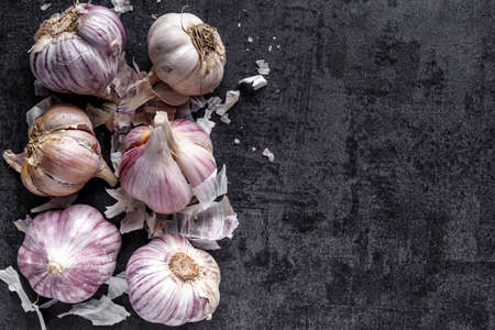 natural food, heads of garlic on a black background. Top view. Copy space.の写真素材