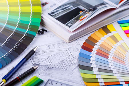 Interior designer's working table, an architectural plan of the house, a color palette. Drawings and plans for house decoration.Construction concept: plan, color samples, rollerのeditorial素材