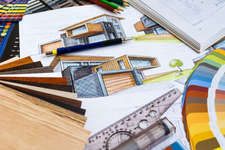 Interior designer's working table, an architectural plan of the house, a color palette. Drawings and plans for house decoration.Construction concept: plan, color samples, rollerのeditorial素材