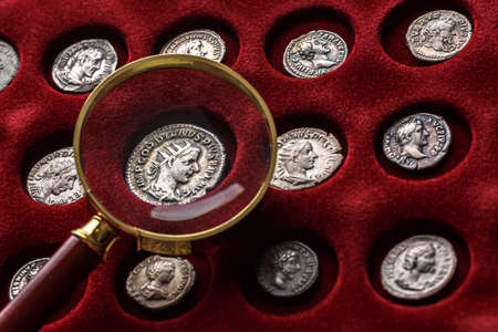 Numismatics.Authentic silver denarius, antoninianus of ancient Rome. A collector holds an old coin. Ancient coin of the Roman Empireの写真素材
