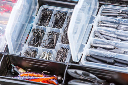 A large fisherman's tackle box fully stocked with lures and gear for fishing.fishing lures and...