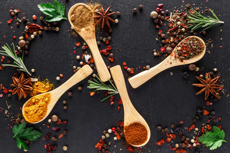 Various spices a vintage spoons on stone table. Colorful Herbal and Spices Oriental marketplace.Top...