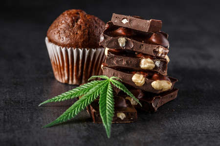 Cupcake with marijuana.traditional sponge cake with cannabis weed cbd. Medical marijuana drugs in...
