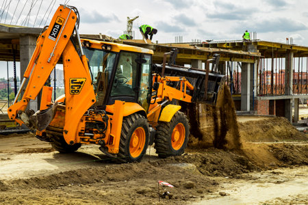 29 august 2019, Kiev, Ukraine: Working Excavator Tractor Digging A Trench At Construction Site.Close-up of a construction site excavatorのeditorial素材