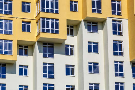 PVC windows on facade of skyscraper. Plastic double glazed windows.Textura of modern buildings, glazed financial and residential surfaces.Building exterior.の写真素材