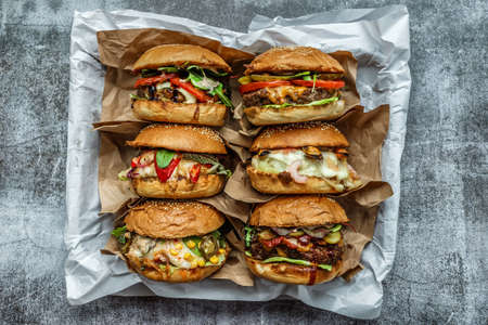 Beef Egg and Bacon Burger Served in Restaurant. American fastfood. Tasty Gourmet on Wooden Table.Beef burgers on wooden plateの写真素材