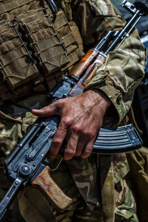 Hands and chests of soldiers in uniforms with machine guns.mashine gun ak - 47 - kalashnikovの写真素材