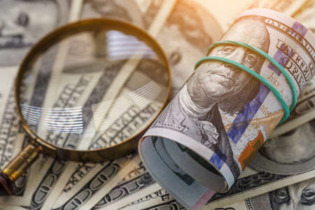 Money american hundred dollar bills.Closeup of assorted American banknotes.US currency scattered on...