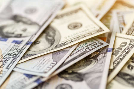 Money american hundred dollar bills.Closeup of assorted American banknotes.US currency scattered on the table.america currency dollor currency.World economic crisis associated with coronovirus.の写真素材