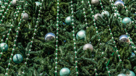 New Year tree at the Christmas market.merry christmas, cute festive decoration close up, beautiful toys for new year. Good New Year spirit.の写真素材