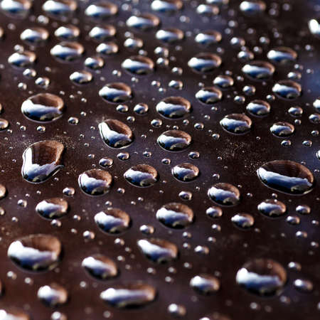 Pattern of water drops in a shining metallic surface with sky reflections, Water droplet on the car hood. Realistic pure water droplet water drops for creative banner designの写真素材