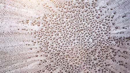 Pattern of water drops in a shining metallic surface with sky reflections, Water droplet on the car hood. Realistic pure water droplet water drops for creative banner designの写真素材