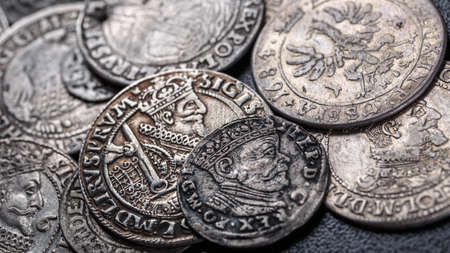 Closeup view of medieval European silver coins.Zygmunt III Waza.Ancient silver coins.Numismatics.silver coins covered in dirt.Antikvariat.の写真素材