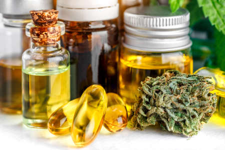 Green leaves of medicinal cannabis with extract oil.Medical marijuana flower buds. Hemp buds - medical marijuana concept.isolated on whiteの写真素材