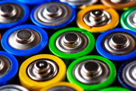 Energy abstract background of colorful batteries.Used batteries from different manufacturers, waste,...