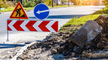 Road signs! Road works with trucks and traffic signs.road works road blocked signs and traffic cones diversion access only; Barriers and road signs.の写真素材