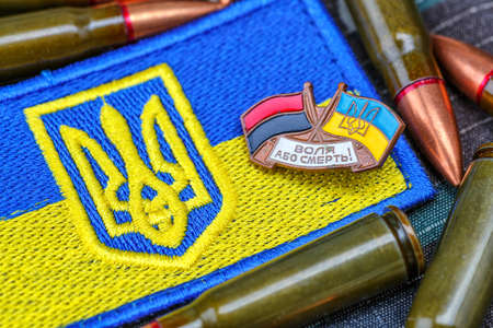 Fabric curved flag of Ukraine, UA. Blue and yellow colors.Ukraine patch on army uniform.Stop war.Patriotism.Concept of Ukraine.Democracy and politics. Close up shot, backgroundの写真素材