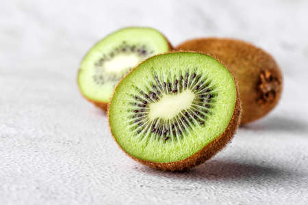 Slices of kiwi fruit on kiwi background.Fresh kiwis on wooden groundの写真素材