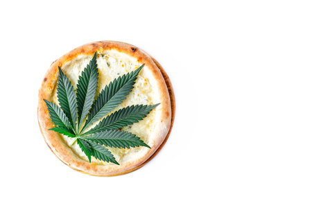 cannabis food with Pizza on wooden tray top view delicious tasty fast food italian traditional pizza cheese with Mozzarella.Cannabis is a standoff between a drug and a medicine.の写真素材