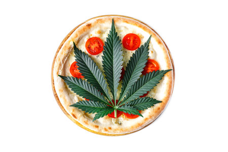 cannabis food with Pizza on wooden tray top view delicious tasty fast food italian traditional pizza cheese with Mozzarella.Cannabis is a standoff between a drug and a medicine.の写真素材