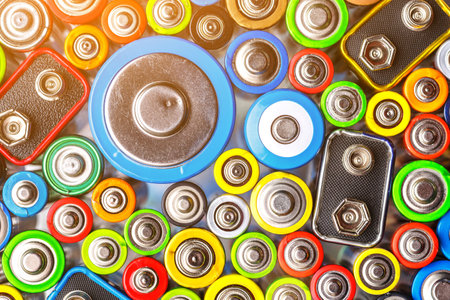 Energy abstract background of colorful batteries.Old used batteries ready for recycling.Used...