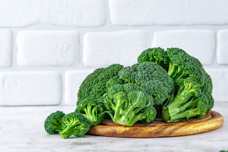 Macro photo of green fresh vegetable broccoli.Cauliflower and broccoli. Fresh green broccoli on a stone table.Broccoli vegetable is full of vitamin.Vegetables for diet and healthy eating.の写真素材