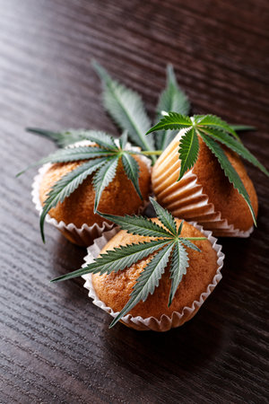 Cupcake with marijuana.traditional sponge cake with cannabis weed cbd. Medical marijuana drugs in food dessert, ganja legalization.の写真素材