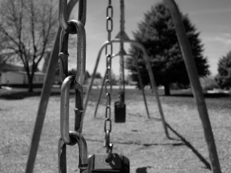 Close-up of chains on a swing-set at a park