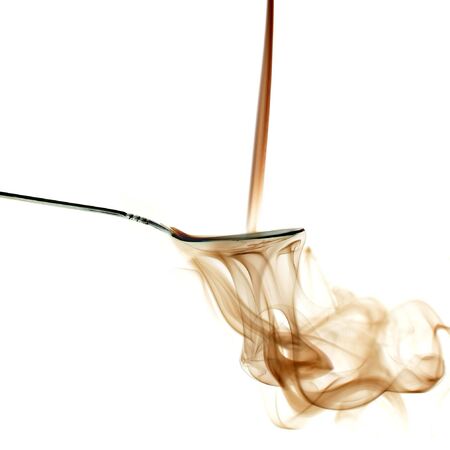 A trail of smoke pouring down on a spoonの写真素材