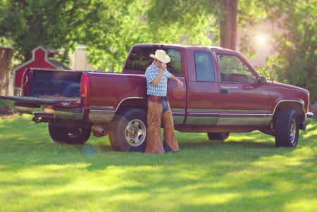 A cowboy leaning against his truckの写真素材