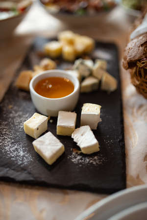 Dish cheese plate with honey. Concept: food, restaurant, holiday