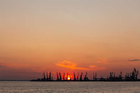 Summer orange sunset of the Sea of Azov against the backdrop of the Berdyansk port.の写真素材