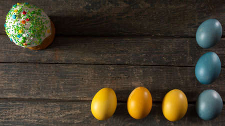 Painted eggs for Easter in the colors of the flag of Ukraine and Easter cake. Yellow and blue...