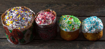 4 Easter cakes with different toppings and different sizes. On wood texture. Concept: food, holidayの写真素材
