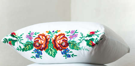 Flowers embroidered with threads on a white pillow. Ukrainian national styleの写真素材