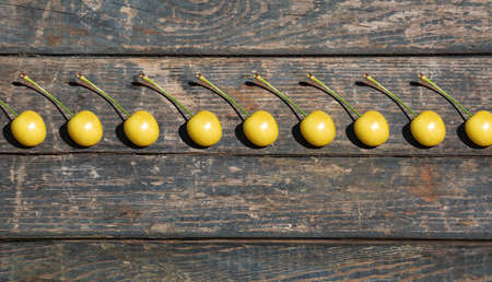 yellow cherry on a wooden texture. boards. Rural, gardening, vegetable garden, fruitsの写真素材