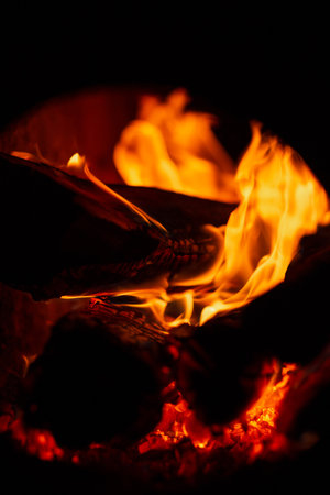 Burning firewood in the fireplace in the oven. fire texture on black background