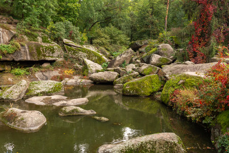 Large stones by the lake in the forest in Sofievka park in Umanの写真素材