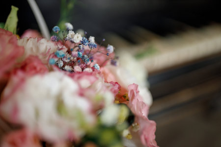 A pink basket of bright flowers stands on the piano