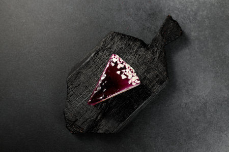 Sumptuous blueberry cheesecake on a captivating black background. A tempting delight for dessert enthusiasts and food photographyの写真素材