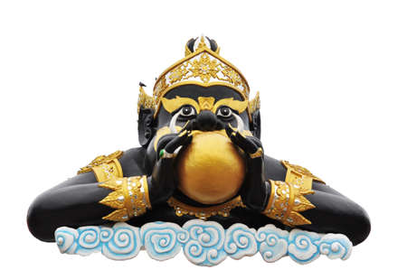 Statue of black deity called Rahu on white background の写真素材