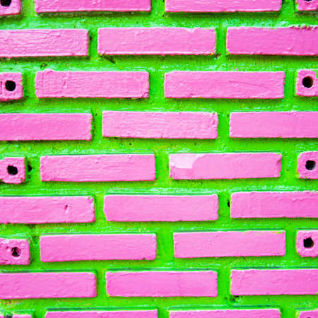 Green and pink  brick wall background の写真素材
