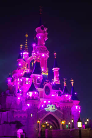 Paris, France, 18 February 2012 - Disneyland Paris Castle illuminated at night during the 20th anniversary. Disneyland Paris is a holiday and recreation resort in Paris. It is the most visited themed attraction of Europe.のeditorial素材
