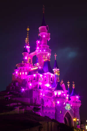 Paris, France, 18 February 2012 - Disneyland Paris Castle illuminated at night during the 20th anniversary. Disneyland Paris is a holiday and recreation resort in Paris. It is the most visited themed attraction of Europe.のeditorial素材