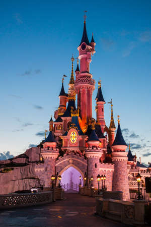 Paris, France, 2 August 2012 - Disneyland Paris Castle illuminated at sunset. Disneyland Paris is an holiday and recreation resort in the eastern suburbs of Paris, France.のeditorial素材