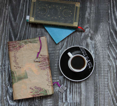 Notebook, book and coffee - still lifeの写真素材