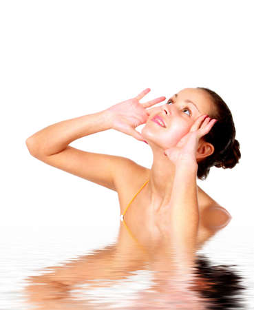 Beautiful young woman reflected in waterの写真素材