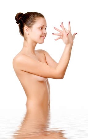 Perfect female torso. On a white background with reflection in waterの写真素材