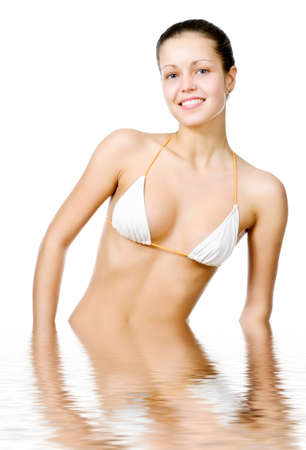 Beautiful young woman reflected in waterの写真素材